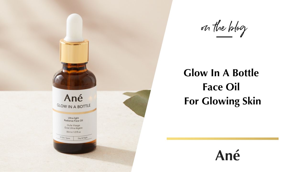 Glow in Bottle Luxury Lightweight Face Oil in an amber glass bottle with a gold and white pipette against a natural background. 