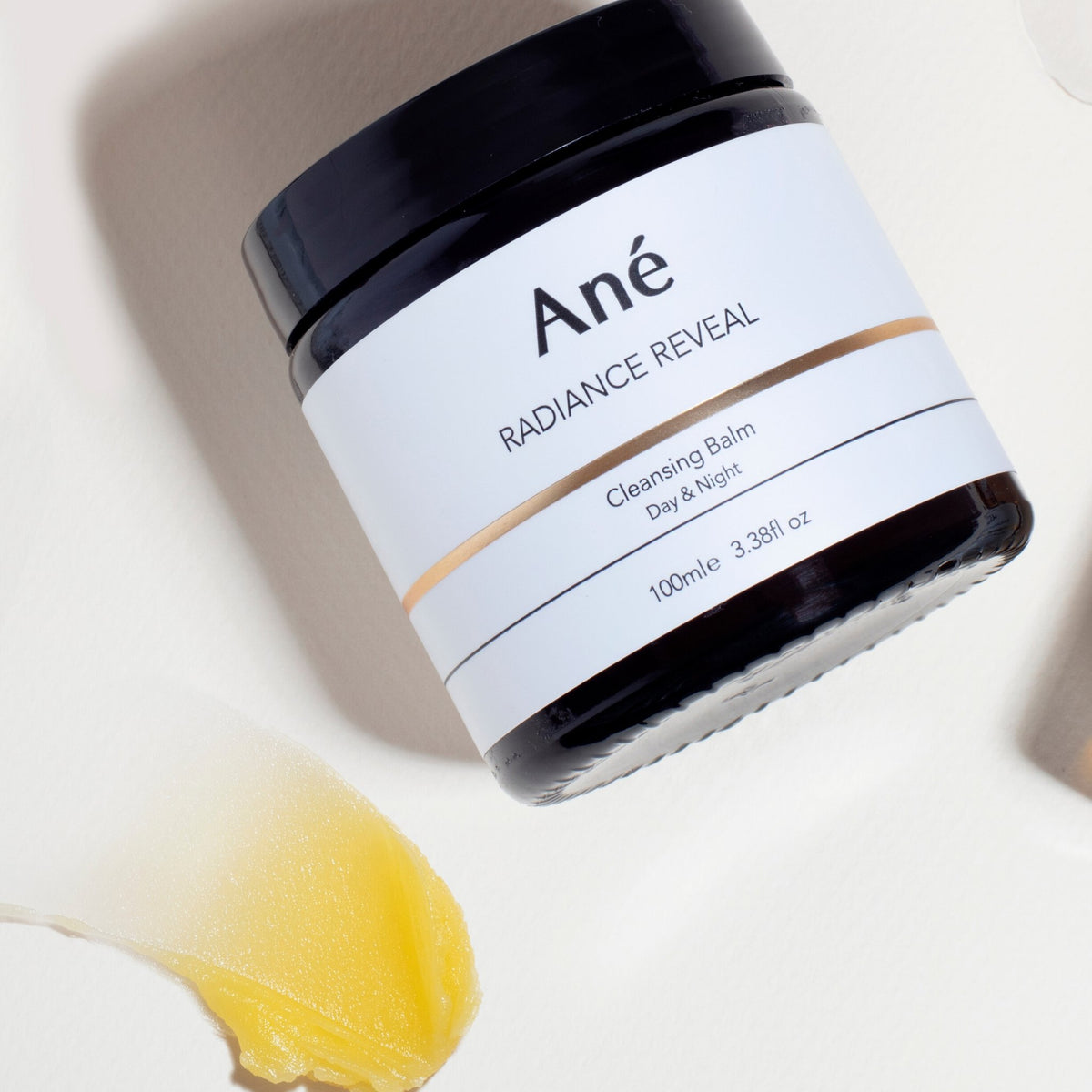 Ané Radiance Reveal Cleansing Balm jar with product sample